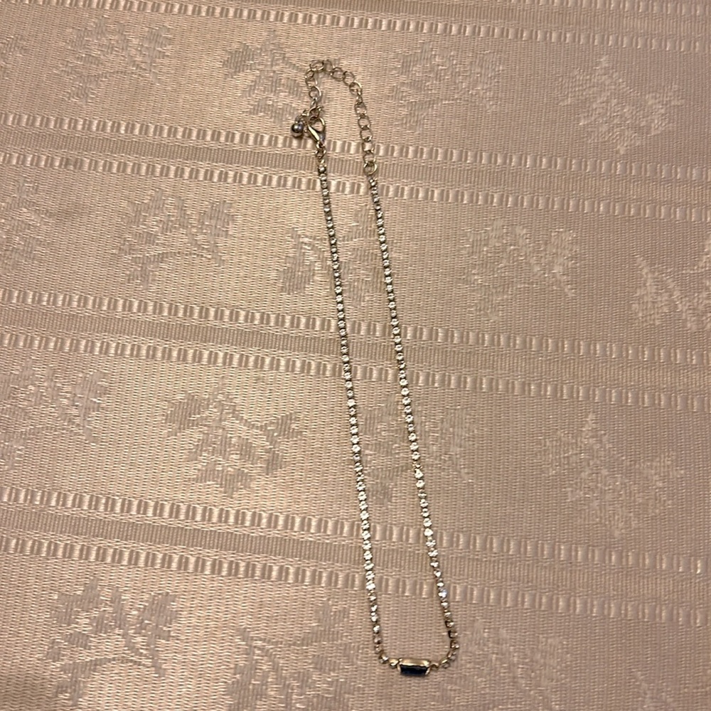 This is a silver diamond necklace.